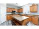 Modern kitchen with an island, stainless steel appliances, and wood cabinets at 10288 Grizzly Forest Dr, Las Vegas, NV 89178