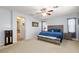 Large main bedroom featuring a king bed, carpet floors, and ensuite bathroom at 10288 Grizzly Forest Dr, Las Vegas, NV 89178