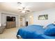 Spacious main bedroom features a ceiling fan, carpet floors, and large TV at 10288 Grizzly Forest Dr, Las Vegas, NV 89178