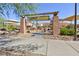 A stylish entry to the playground includes custom signage, picnic benches, and desert landscaping at 10288 Grizzly Forest Dr, Las Vegas, NV 89178