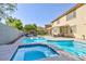 Backyard pool with mountain views, a spa and a covered lounge area for relaxing and entertaining at 10288 Grizzly Forest Dr, Las Vegas, NV 89178