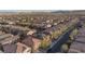 Aerial view of houses in a neighborhood, many with solar panels, against a mountain backdrop at 10956 Hunting Hawk Rd, Las Vegas, NV 89179