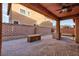 Covered patio and grill in paved backyard at 10956 Hunting Hawk Rd, Las Vegas, NV 89179