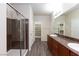 Bathroom featuring wood-look floors, double sinks and large walk-in shower at 10956 Hunting Hawk Rd, Las Vegas, NV 89179