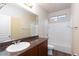 Bathroom featuring a sink, vanity, and a bathtub with white tiled surround and modern fixtures at 10956 Hunting Hawk Rd, Las Vegas, NV 89179