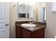 Bathroom featuring a vanity sink, dark countertops, and decorative mirror at 10956 Hunting Hawk Rd, Las Vegas, NV 89179