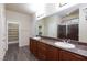 Bathroom featuring dual sinks, walk-in shower and a large walk-in closet at 10956 Hunting Hawk Rd, Las Vegas, NV 89179