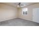 Inviting bedroom with a ceiling fan, a window with blinds, and plush carpeting at 10956 Hunting Hawk Rd, Las Vegas, NV 89179