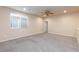 Expansive carpeted bedroom with a ceiling fan, and plenty of natural light at 10956 Hunting Hawk Rd, Las Vegas, NV 89179