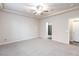Large bedroom features neutral carpet, ceiling fan, and ensuite bathroom at 10956 Hunting Hawk Rd, Las Vegas, NV 89179