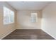 Bedroom with natural light from two windows and wood-look flooring at 10956 Hunting Hawk Rd, Las Vegas, NV 89179