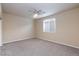 Bright bedroom with ceiling fan, plush carpet, and a window providing ample natural light at 10956 Hunting Hawk Rd, Las Vegas, NV 89179