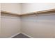 This small closet features carpeted floors and clothing rods at 10956 Hunting Hawk Rd, Las Vegas, NV 89179
