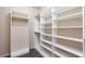 Walk-in closet with custom white shelving and wood-look floors at 10956 Hunting Hawk Rd, Las Vegas, NV 89179