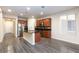 Modern kitchen features stainless steel appliances, spacious island, granite countertops, and wood flooring at 10956 Hunting Hawk Rd, Las Vegas, NV 89179