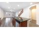 Kitchen island with stainless steel sink and dishwasher; wood-look floors throughout at 10956 Hunting Hawk Rd, Las Vegas, NV 89179