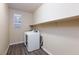 Efficient laundry room featuring a washer, dryer, built-in shelving, and natural light at 10956 Hunting Hawk Rd, Las Vegas, NV 89179