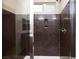 Shower featuring brown stone and a glass enclosure at 10956 Hunting Hawk Rd, Las Vegas, NV 89179