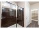 Walk-in shower features brown tile and a glass enclosure at 10956 Hunting Hawk Rd, Las Vegas, NV 89179