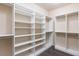 Spacious walk-in closet featuring custom white shelving and hardwood floors offers plenty of room for storage at 10956 Hunting Hawk Rd, Las Vegas, NV 89179