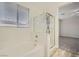 Bright bathroom featuring a soaking tub and a glass-enclosed shower with wood-style floors at 11069 Crystal Crest Ct, Las Vegas, NV 89135