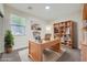 Bright home office featuring a large desk, bookshelf, and a large window at 11069 Crystal Crest Ct, Las Vegas, NV 89135