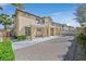 View of the back of the house with a brick driveway and small patio at 1401 Via Savona Dr, Henderson, NV 89052