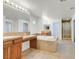 Bathroom features double sinks, vanity area, soaking tub, and glass shower at 1401 Via Savona Dr, Henderson, NV 89052