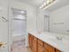 Bathroom with double sinks, wood cabinetry, and a separate toilet and shower at 1401 Via Savona Dr, Henderson, NV 89052