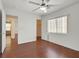 Bright bedroom with ceiling fan, wood floors, and natural light at 1401 Via Savona Dr, Henderson, NV 89052
