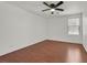 Simple bedroom featuring a ceiling fan, hardwood floors, and a window at 1401 Via Savona Dr, Henderson, NV 89052
