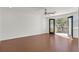 Empty bedroom features hardwood floors and a door to an outdoor balcony at 1401 Via Savona Dr, Henderson, NV 89052