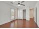 Bedroom with hardwood floors, ceiling fan, and access to closet and balcony at 1401 Via Savona Dr, Henderson, NV 89052