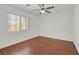 A bright, empty bedroom with hardwood floors and a large window at 1401 Via Savona Dr, Henderson, NV 89052