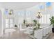 Bright dining room featuring a modern glass table, chandelier and lots of natural light at 1401 Via Savona Dr, Henderson, NV 89052