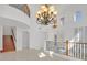 Grand foyer with high ceilings, stairs, decorative railing, and natural light at 1401 Via Savona Dr, Henderson, NV 89052
