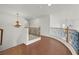 A hallway features hardwood floors, decorative railing and an elegant chandelier at 1401 Via Savona Dr, Henderson, NV 89052