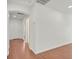 Hallway with beautiful hardwood floors, white walls and trim, and arched doorway at 1401 Via Savona Dr, Henderson, NV 89052