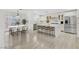 Open kitchen with stainless steel appliances, a marble island, and bright dining space at 1401 Via Savona Dr, Henderson, NV 89052