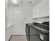 Functional laundry room featuring a washer, dryer, and ample storage space at 1401 Via Savona Dr, Henderson, NV 89052