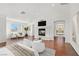 Bright, staged living room with fireplace, hardwood floors, and mountain view at 1401 Via Savona Dr, Henderson, NV 89052