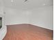 An empty living room features hardwood floors and white walls at 1401 Via Savona Dr, Henderson, NV 89052