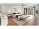 A main bedroom boasts hardwood floors, and an outdoor balcony with views at 1401 Via Savona Dr, Henderson, NV 89052