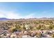 Serene aerial shot of the community showcasing manicured lawns, green trees, golf course, and mountain backdrop at 1634 Georgia Ave, Boulder City, NV 89005