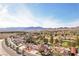 Overhead view of a home with scenic mountain views, desert landscaping, and a neighborhood golf course at 1634 Georgia Ave, Boulder City, NV 89005