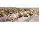 Aerial view of a two-story home with a tree-lined street, desert landscaping, and a three-car garage at 1634 Georgia Ave, Boulder City, NV 89005