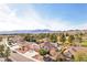 Overhead view of a charming home with lush landscaping, a three-car garage, and mountain views at 1634 Georgia Ave, Boulder City, NV 89005
