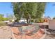 Serene backyard seating area with mature landscaping and a view of the refreshing pool area at 1634 Georgia Ave, Boulder City, NV 89005