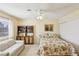 Bedroom featuring neutral colored walls, a floral patterned bed, a ceiling fan, and a small loveseat at 1634 Georgia Ave, Boulder City, NV 89005