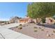 Charming two-story home featuring a three-car garage, mature tree, and desert landscaping at 1634 Georgia Ave, Boulder City, NV 89005